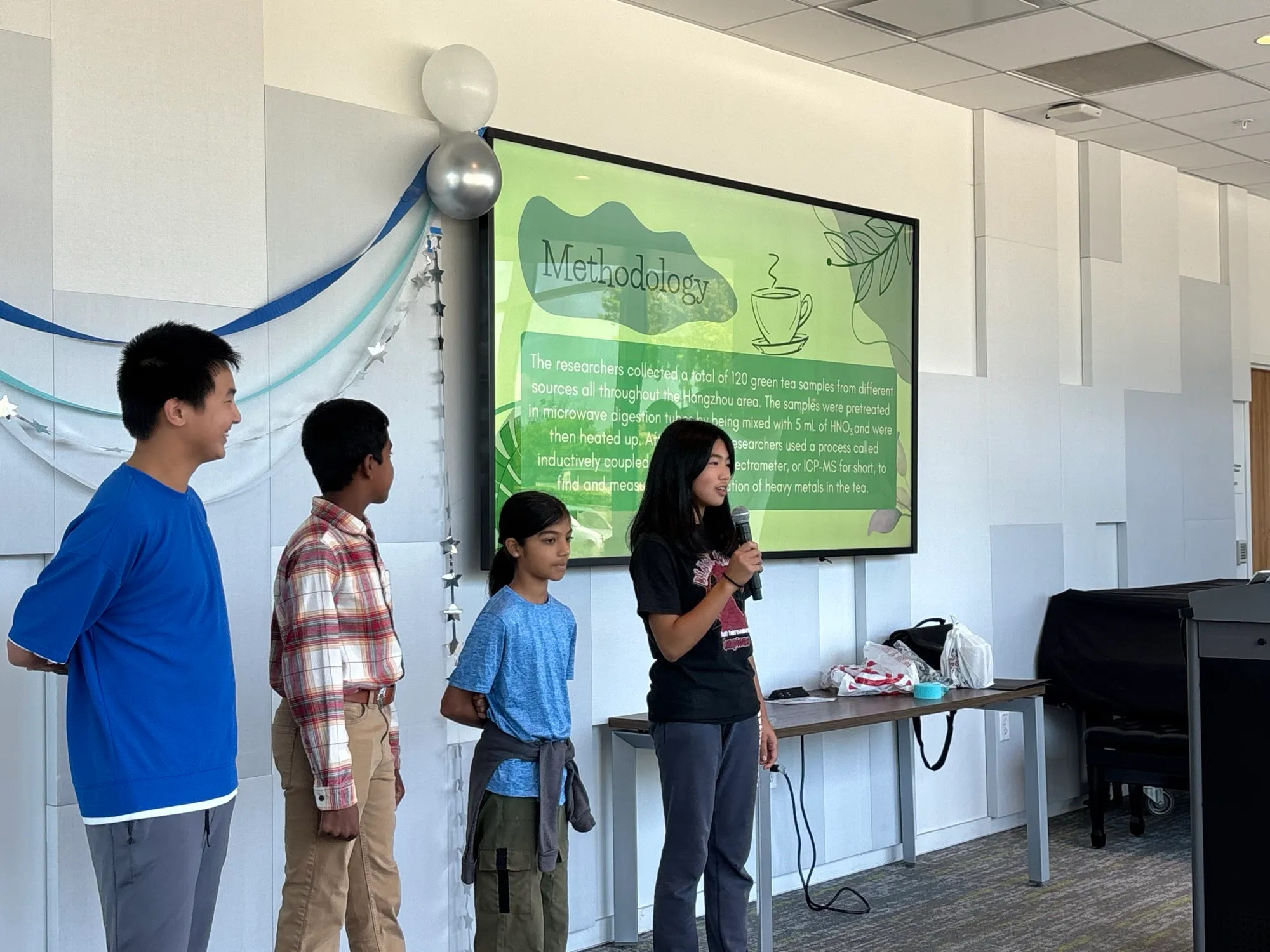 Chemistry cohort presenting their methodology slide on heavy metals in green tea.