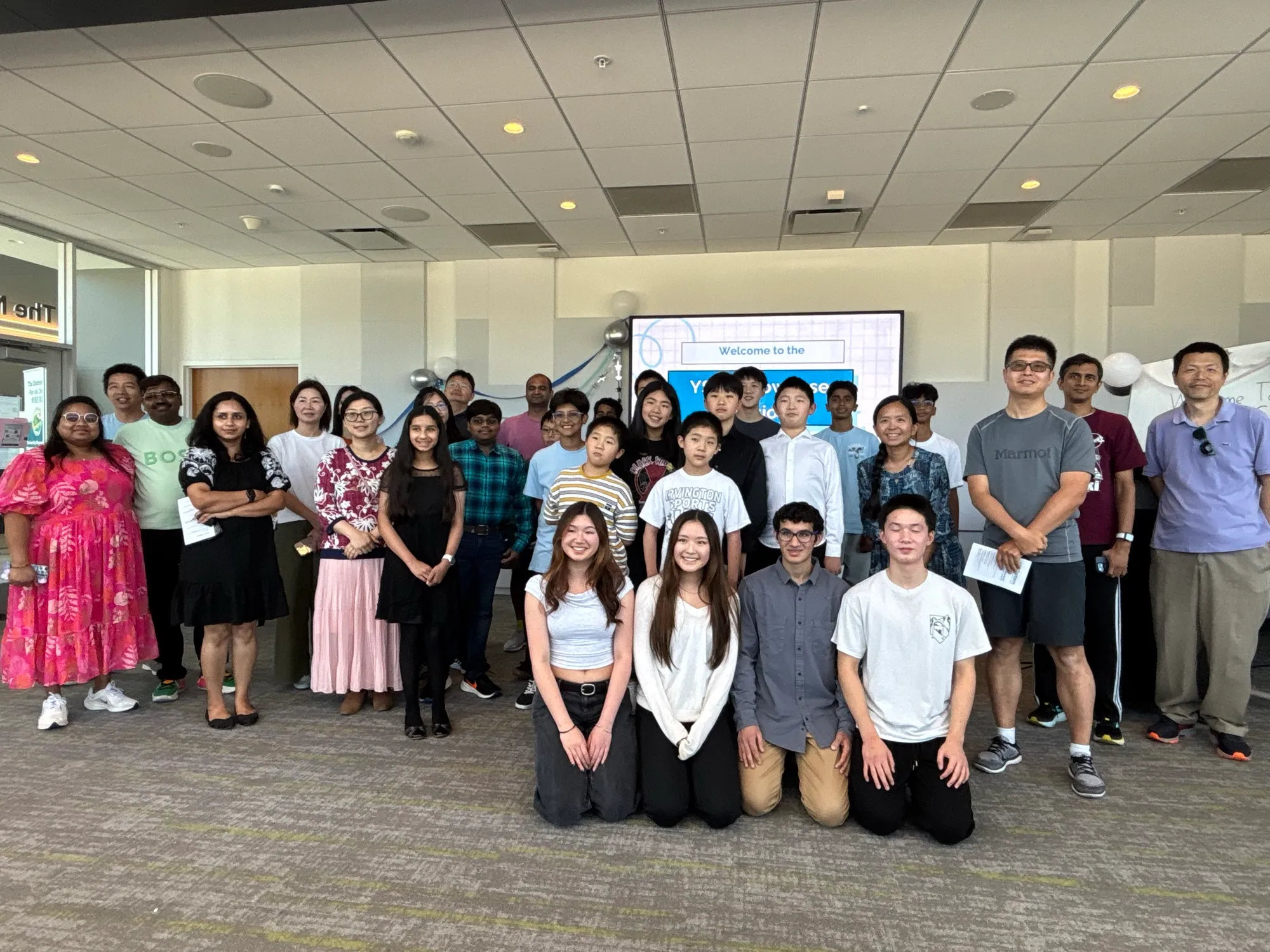 YSJC 2025 cohort — students, mentors, and parents at Showcase Day, Newark Library.