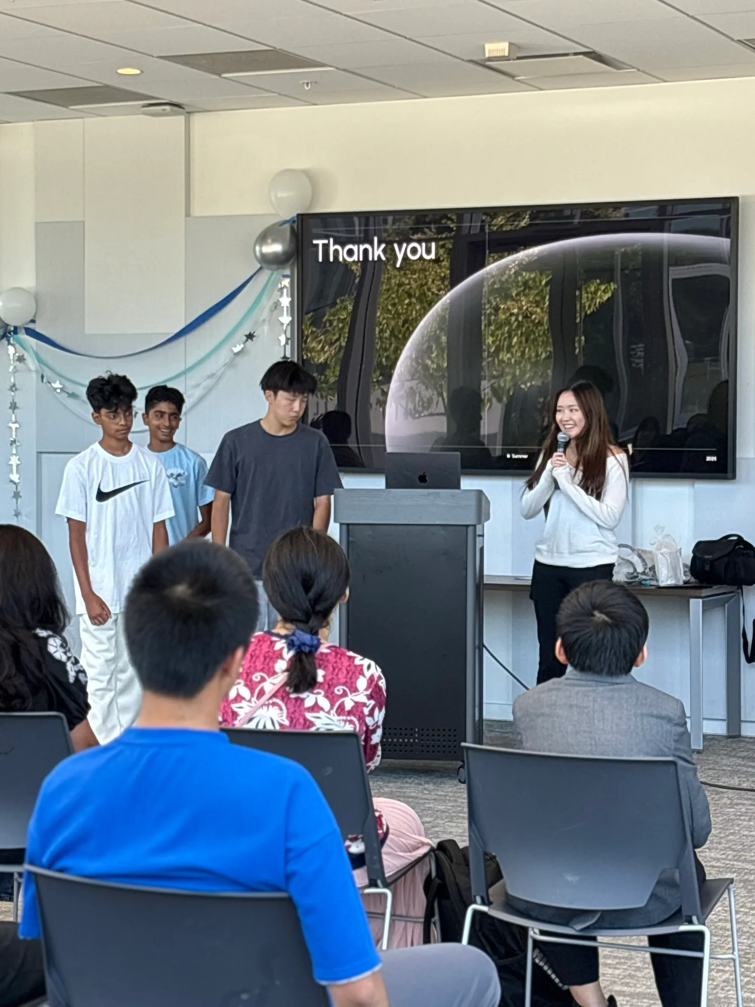 Presenters at the 'Thank you' slide closing their final presentation.